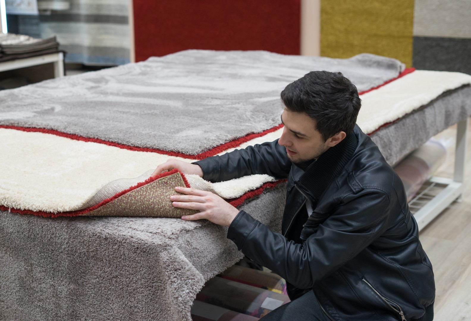 Technician inspecting a carpet for mold and mildew damage.